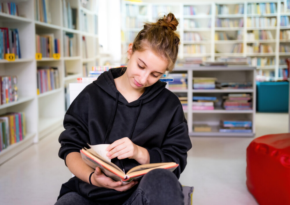 Student reading book in library